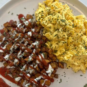scrambled eggs and potatoes with ketchup and ranch