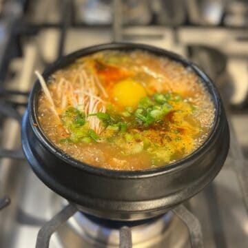 korean tofu soup in stone pot on stove